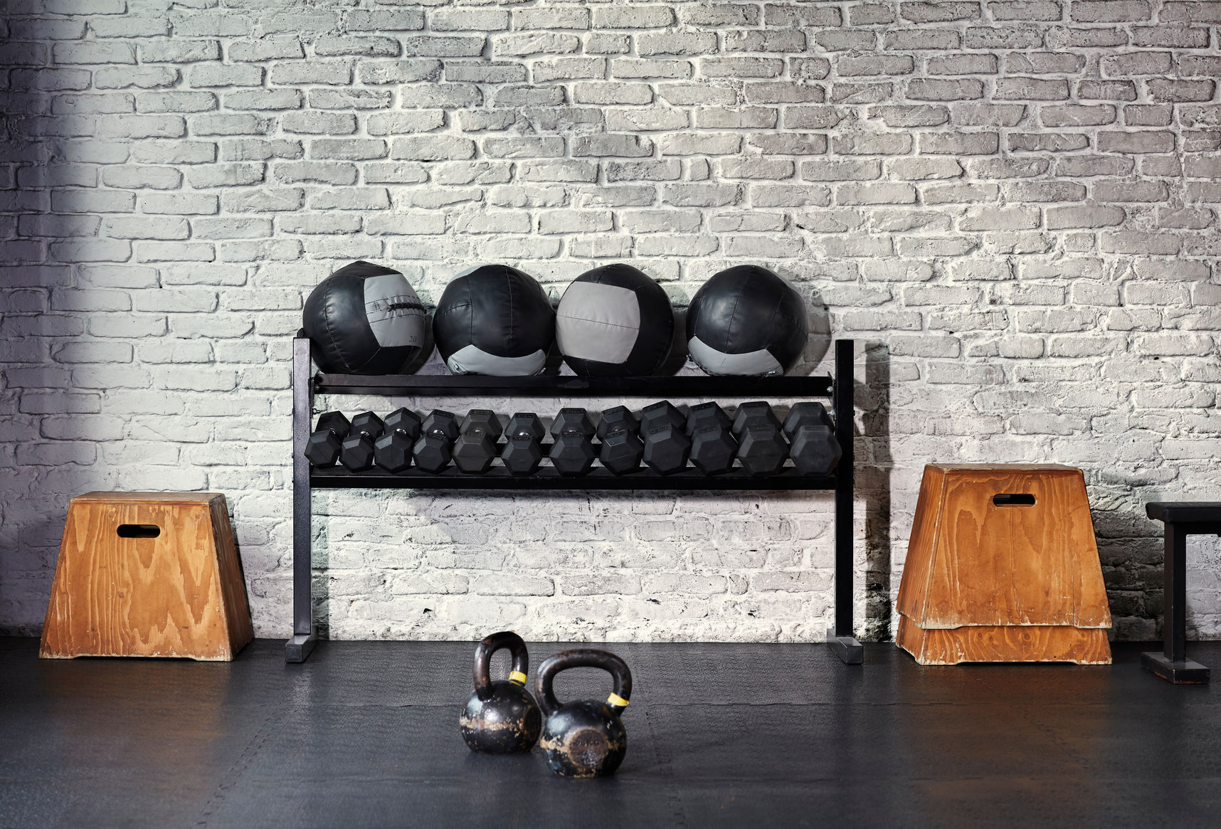 A Sunlit Empty Gym With A Rack Of Weights.